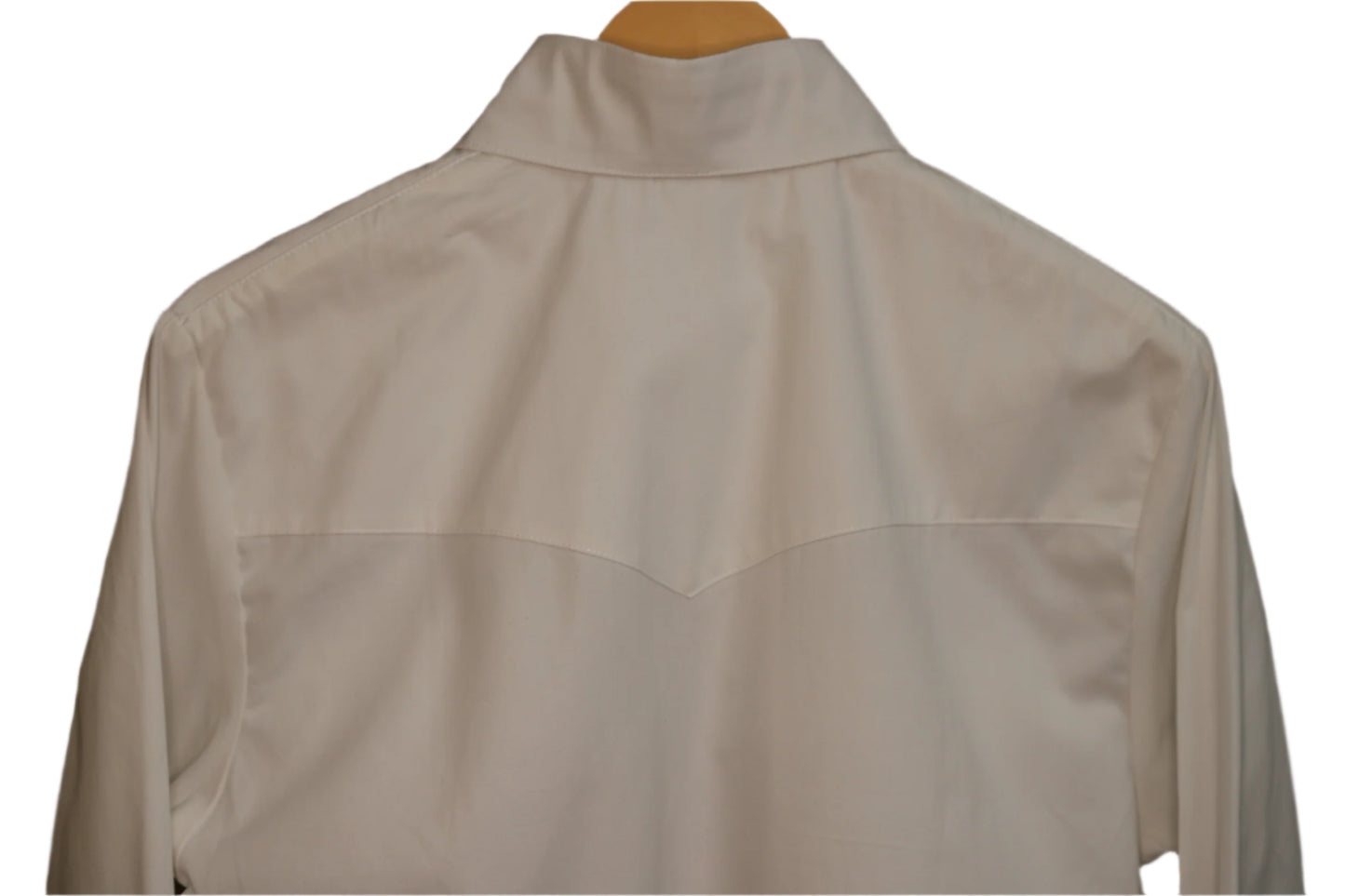 White shirt on a hanger against a brown background