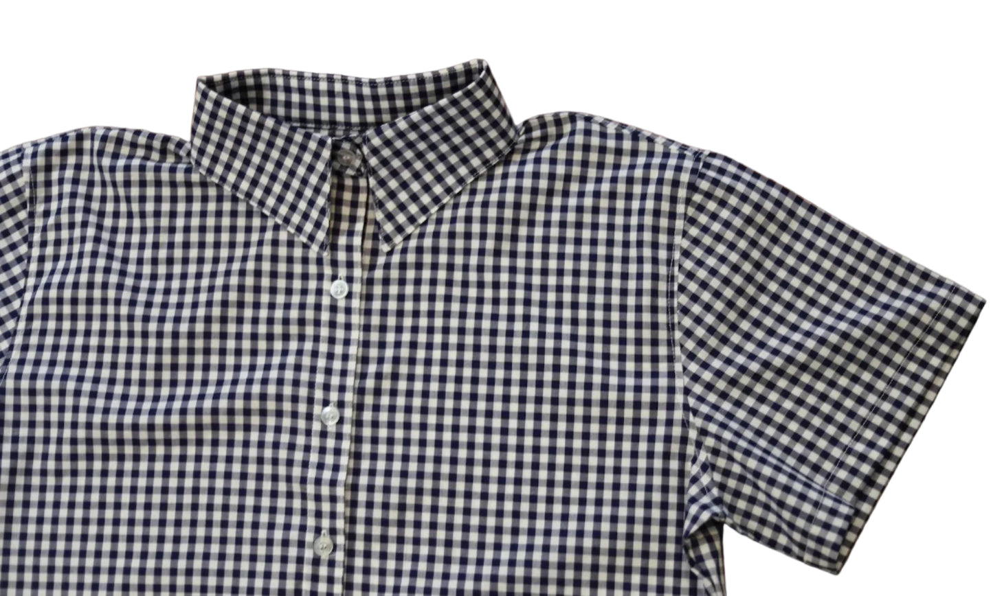 short sleeve close up of sleeve of women's navy blue gingham top