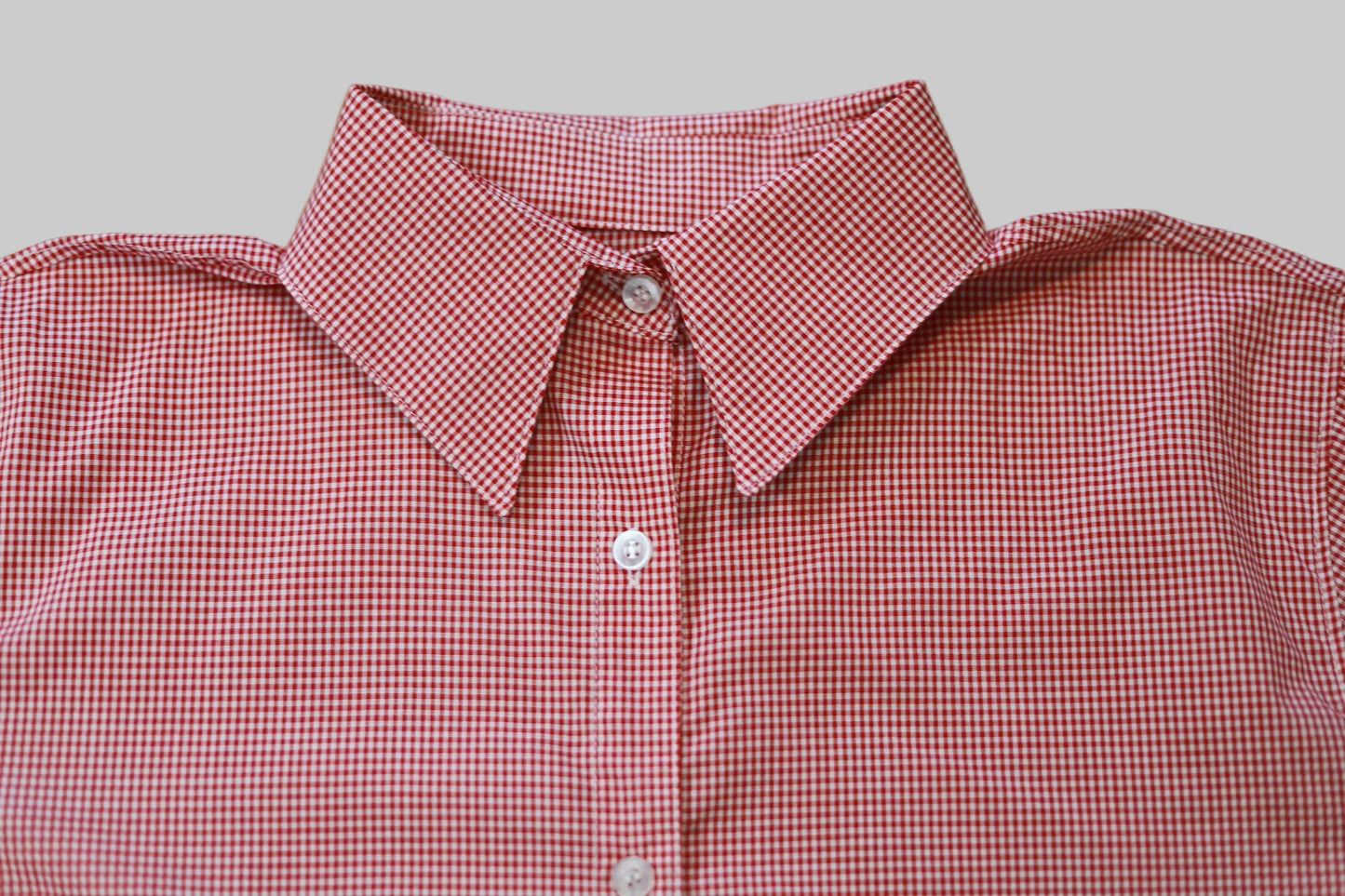 Red and white checkered shirt on a wooden surface