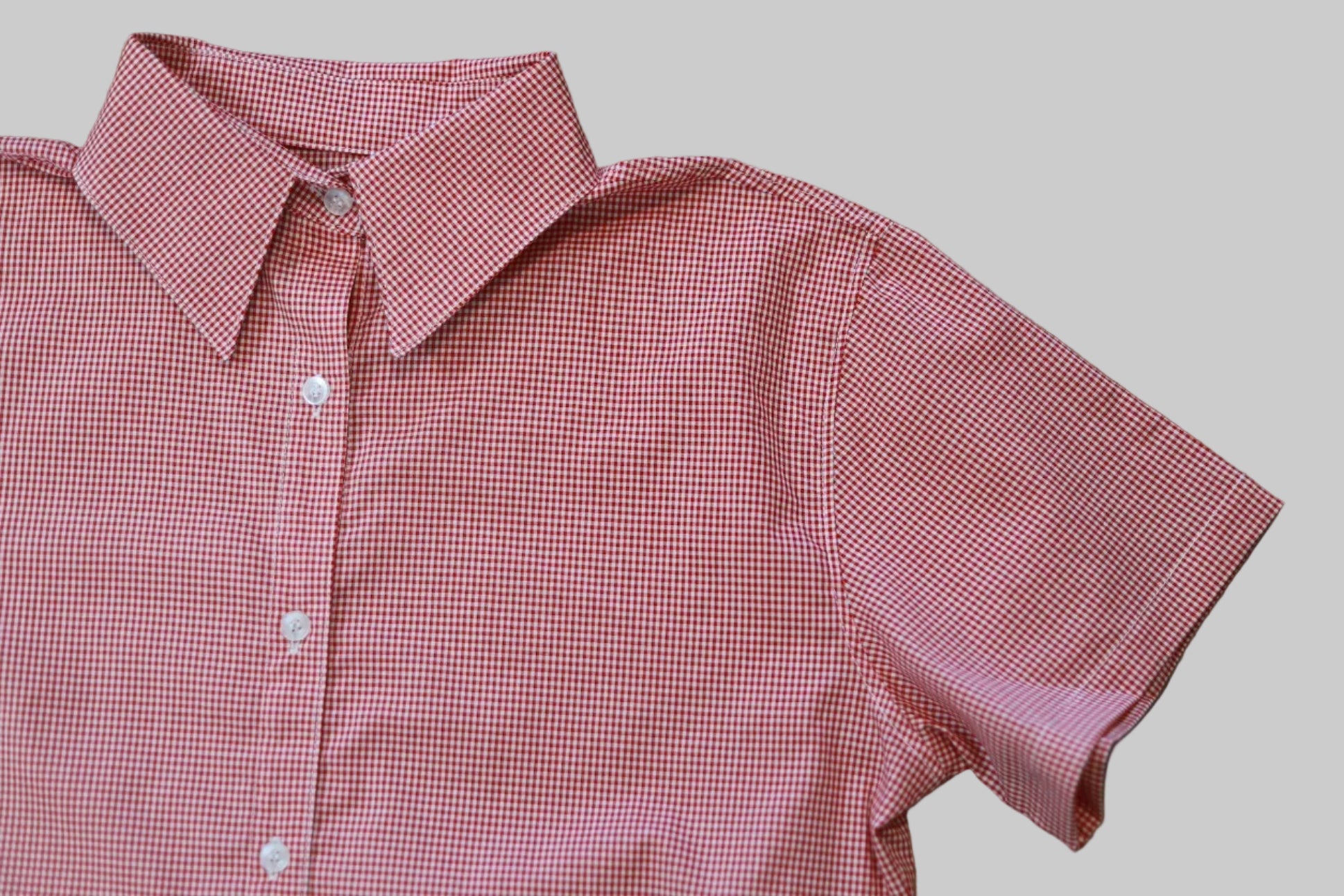 Red checkered shirt on a wooden surface