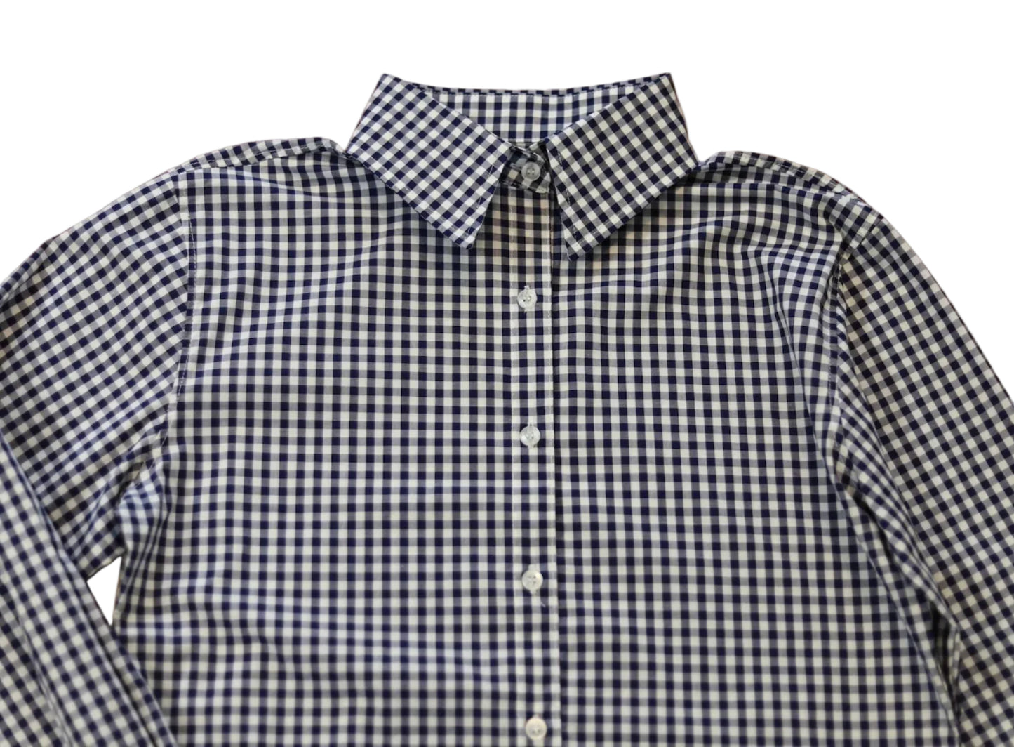 woman in cowgirl hat wearing gingham navy blue long sleeve shirt button down