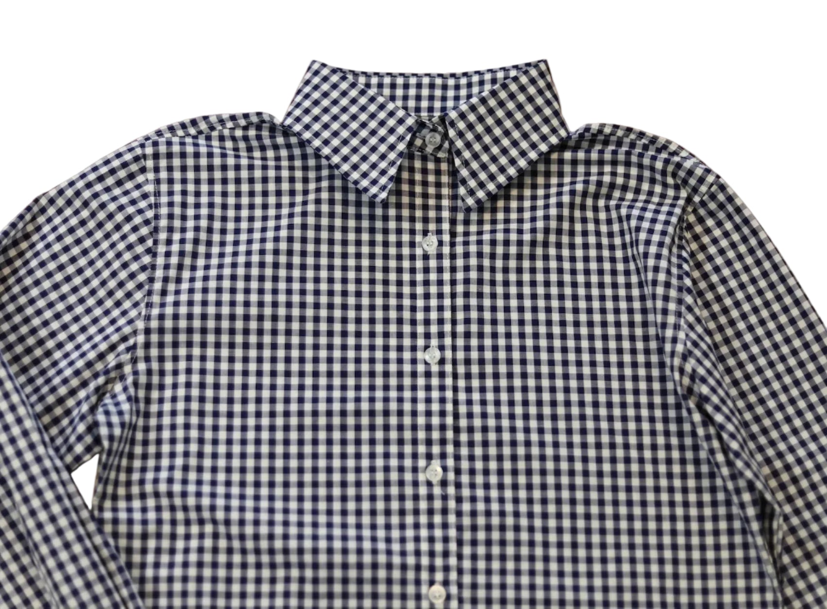 woman in cowgirl hat wearing gingham navy blue long sleeve shirt button down