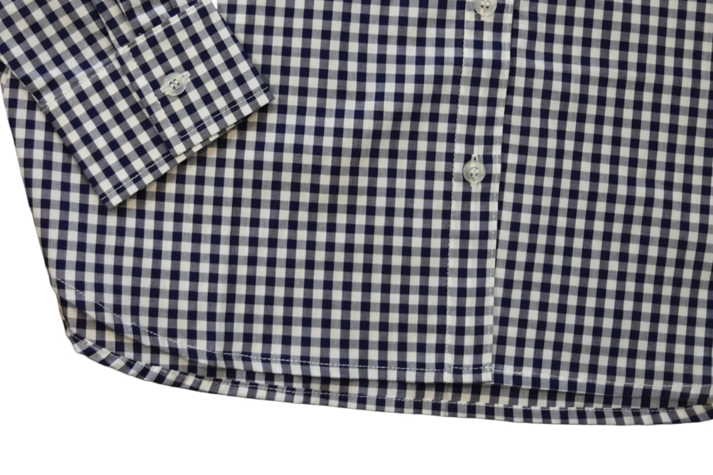 woman in cowgirl hat wearing gingham navy blue long sleeve shirt button down bottom of shirt
